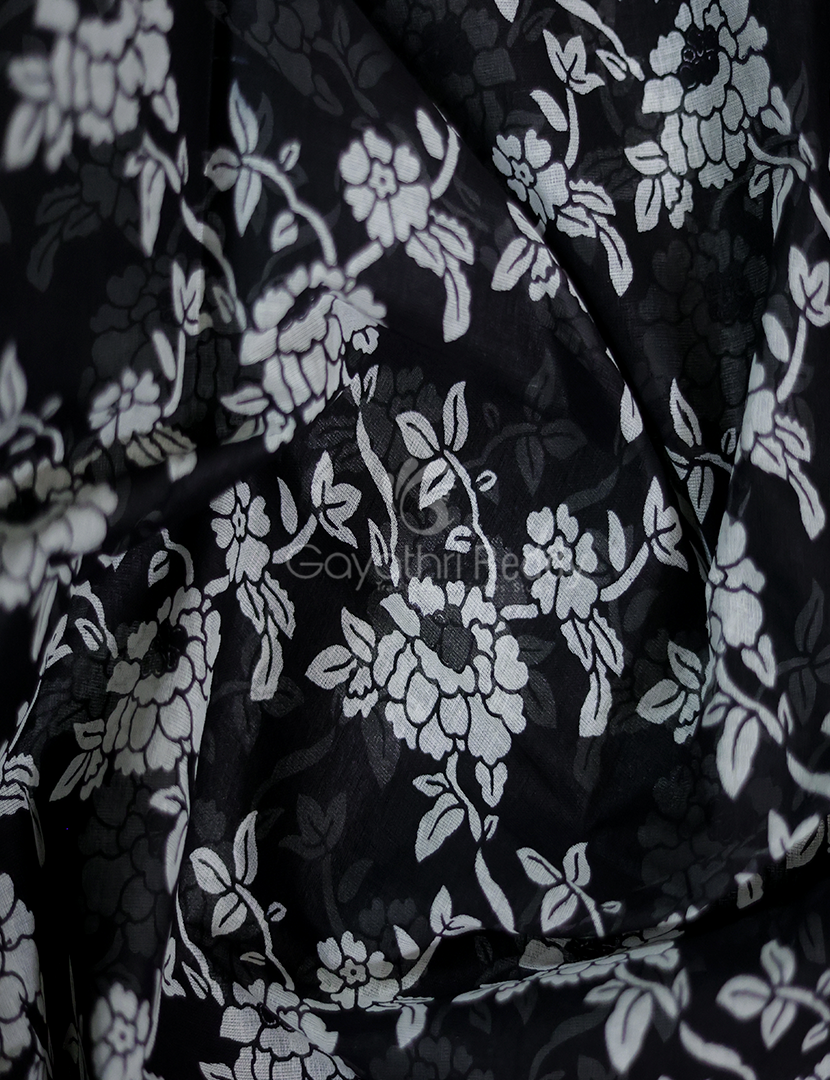 Detailed view of traditional hand-stamped block prints on the black Finlay Organdie cotton saree.