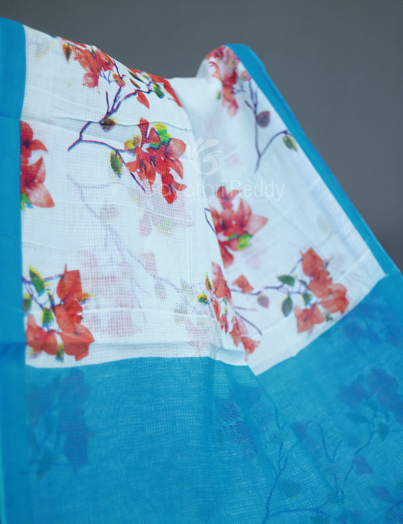 Detailed view of the floral print design on a powder blue and sky blue Munga cotton saree made with pure vegetable dyes.