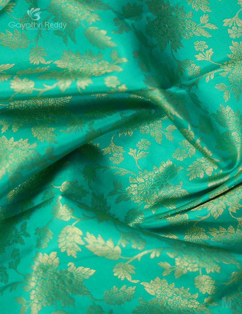 Detailed view of the intricate 7-8 inch border on the mint green Kanchi Pattu lehenga by Gayathri Reddy.