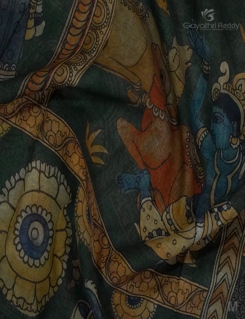 Close-up of Kalamkari artwork on a dark olive green Khadi cotton saree, showcasing detailed hand-painted designs